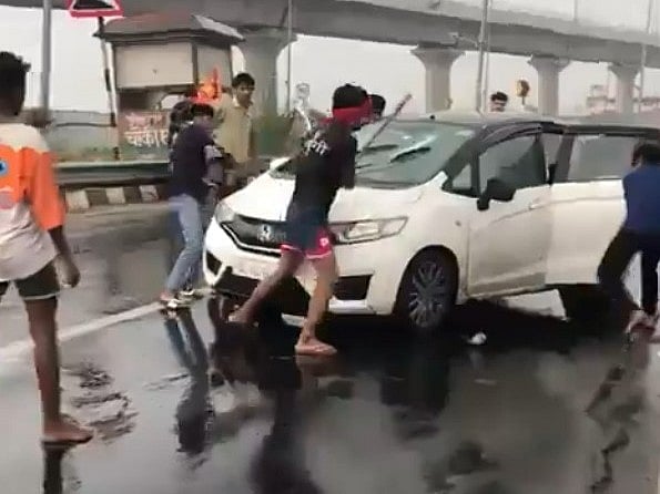 One of the videos shows the Kanwariyas raising slogans around the damaged car.

 - X/@Delhiite_
